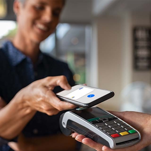 Woman attaching a smartphone to the pos terminal