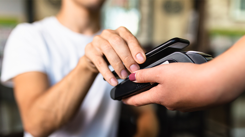 The smartphone is attached to the pos terminal and purchases are paid for using it